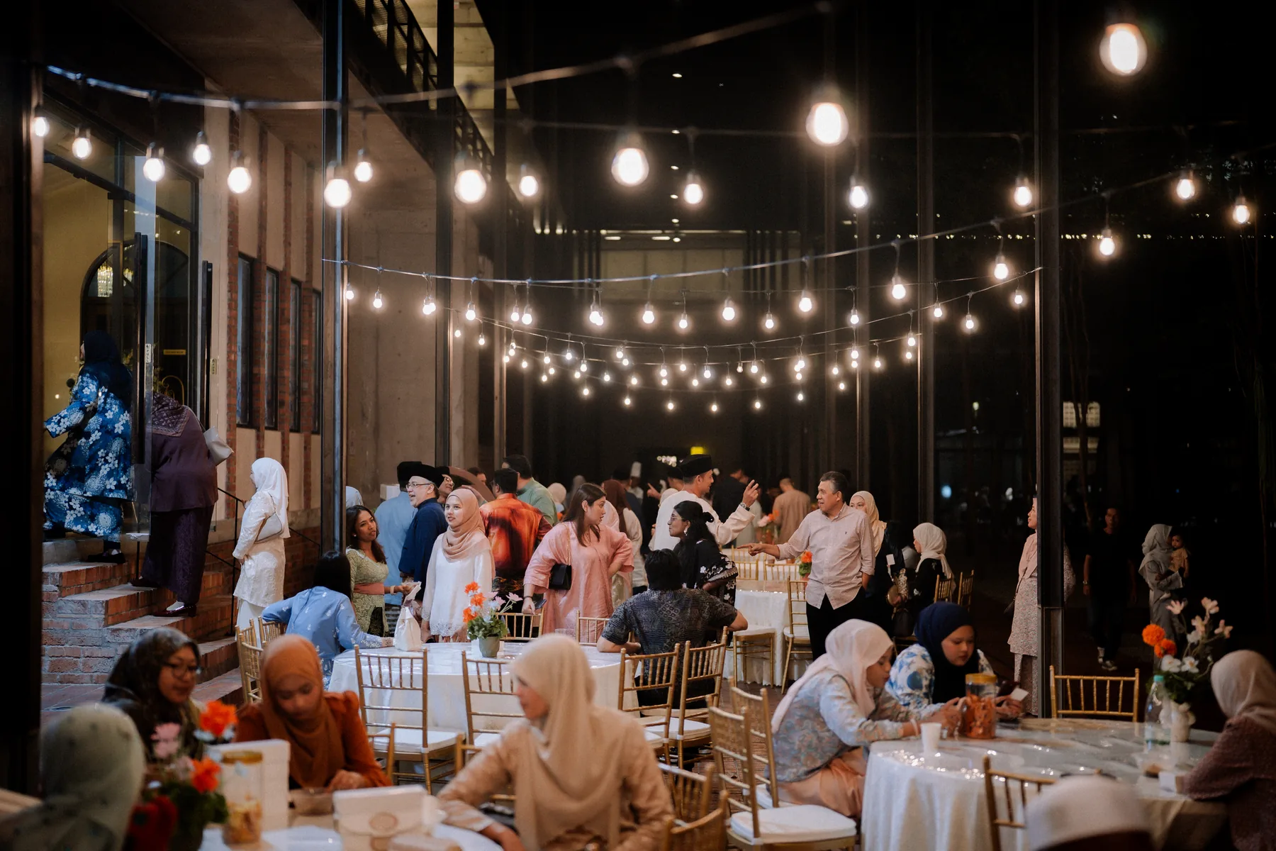Evening event beneath string lights at Luminare Yard